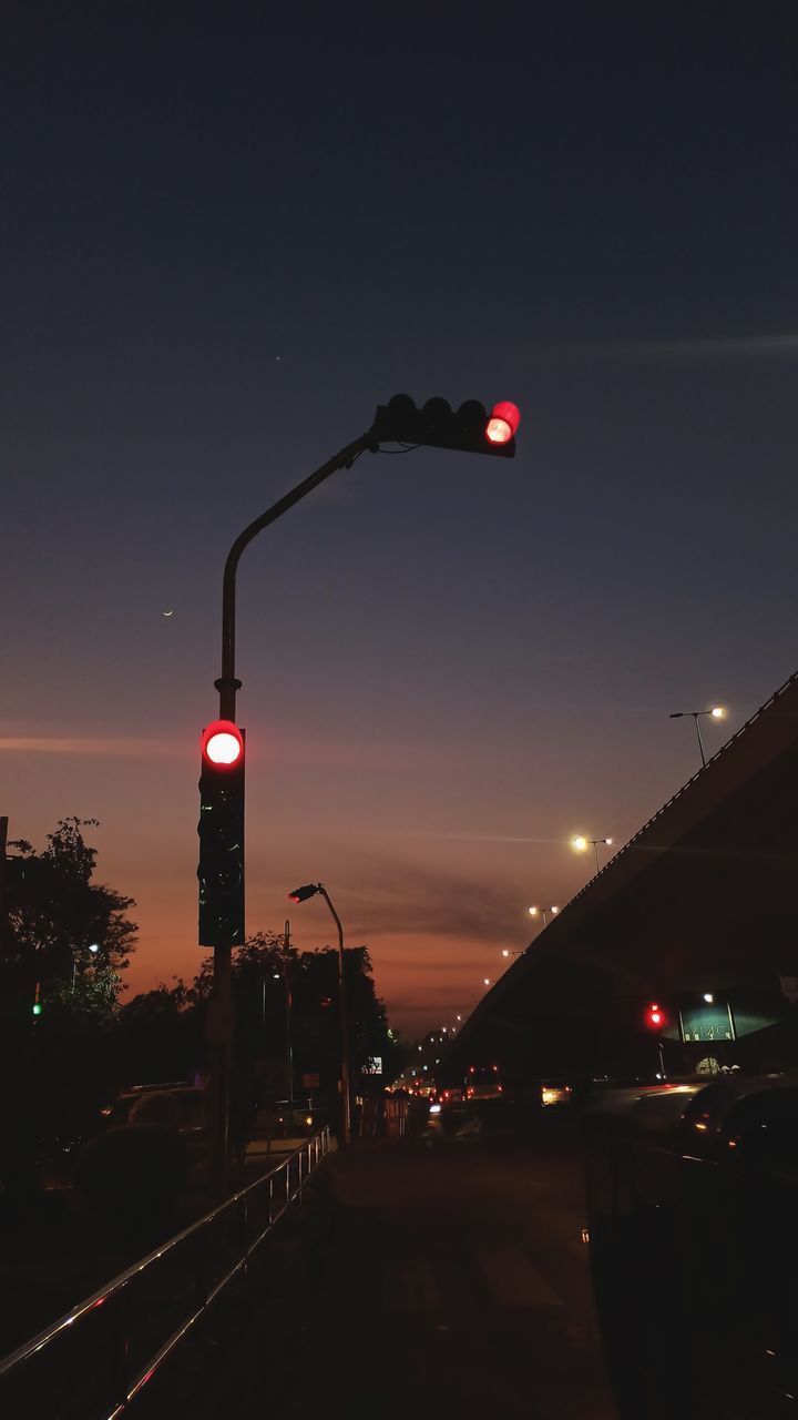 TRAFFIC LIGHT TRAILS ON ROAD AT NIGHT