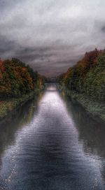 Empty road against cloudy sky