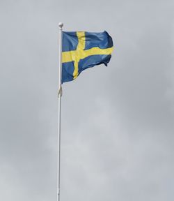 Low angle view of flag against sky