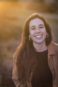 Portrait of smiling woman standing outdoors