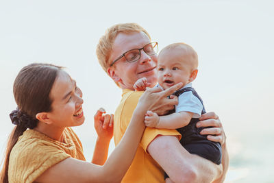 Cheerful family standing on beach