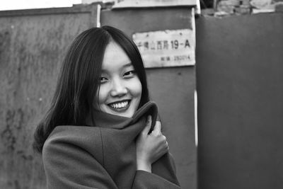 Portrait of smiling young woman using mobile phone