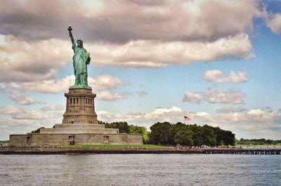 Statue of liberty against cloudy sky