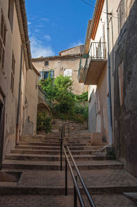 View of alley with houses, staircase and handrail at greoux-les-bains, in the french provence.