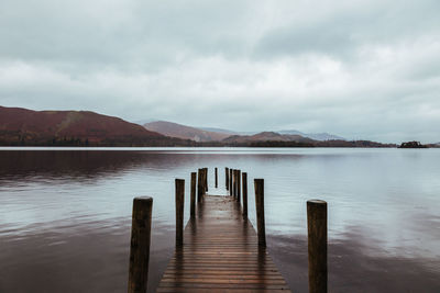 Pier over lake against sky