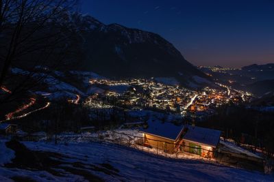 Mountain village icon snow at sunset