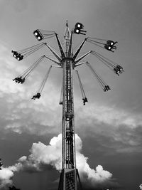 Low angle view of chain swing ride against sky