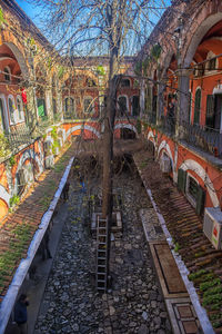 Arch bridge over canal amidst buildings