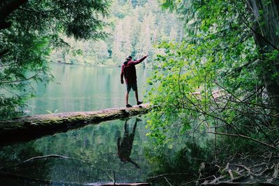 Man walking by river in forest