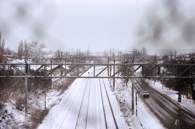 Bridge over river against sky during winter