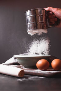 Close-up of person preparing food on table