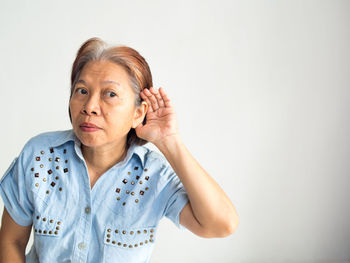 Woman listening against white background