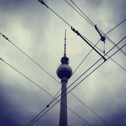 Low angle view of communications tower against sky