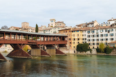 River by built structures against sky