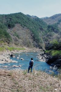 Full length of man walking on mountain against sky