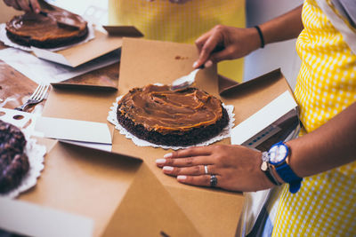 Midsection of woman preparing food on table