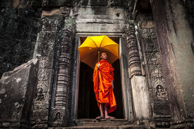 Novice monk in ruined building