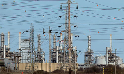 Low angle view of electricity pylon against sky