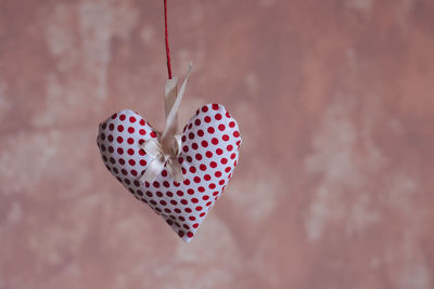 Close-up of heart shape decoration hanging against wall