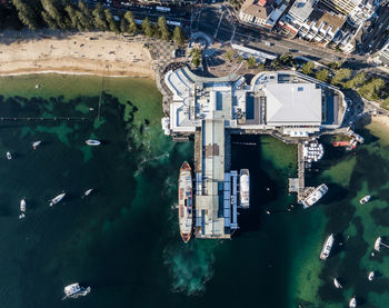 Vertical bird's eye aerial evening drone view of manly wharf, sydney, new south wales, australia.