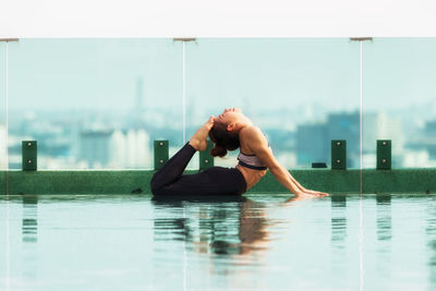 Side view of young woman in swimming pool