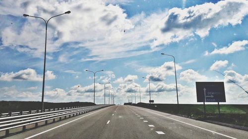 Road by highway against sky