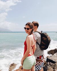 Couple on beach against sky