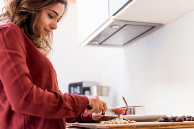 Young woman preparing food at home