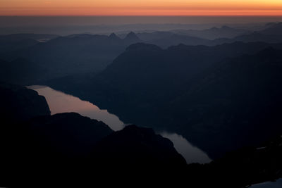 Scenic view of silhouette mountains against sky during sunset