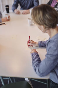 Woman taking notes during meeting