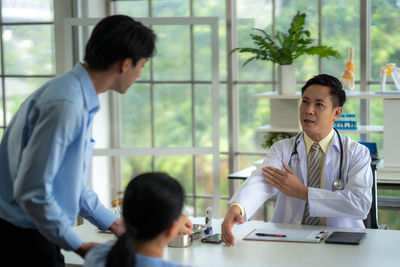 Side view of business colleagues working at office