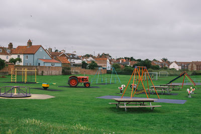 Empty rides in playground against sky