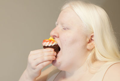 Portrait of young man eating food