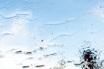 Full frame shot of raindrops on water