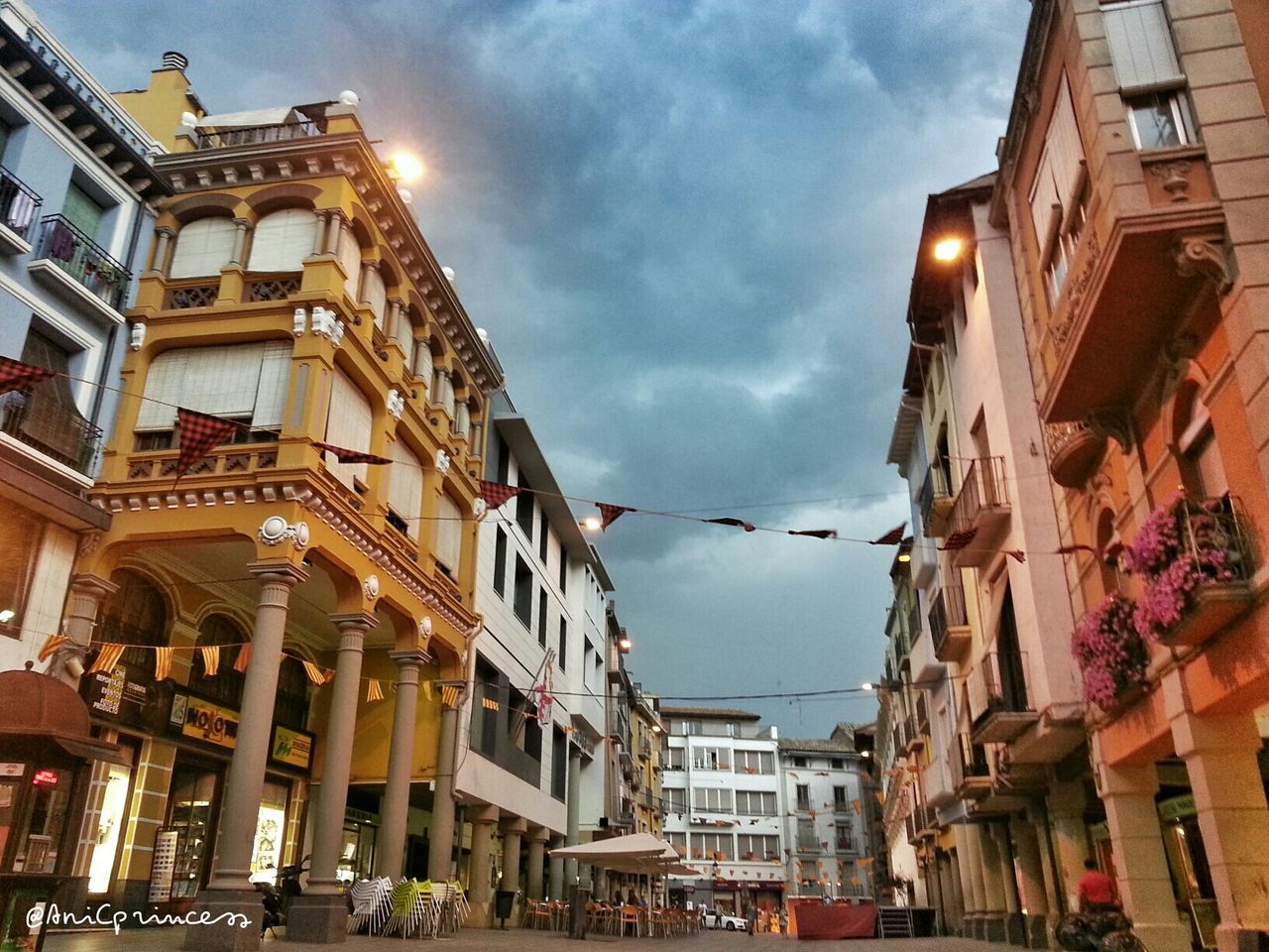 building exterior, architecture, built structure, sky, city, cloud - sky, residential building, street, building, low angle view, residential structure, cloudy, city life, cloud, street light, incidental people, outdoors, city street, day, residential district