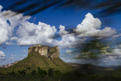 Low angle view of mountain against cloudy sky