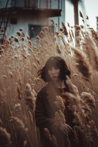 Portrait of woman standing on field