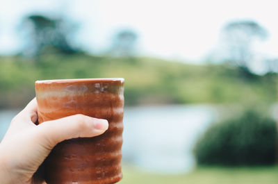 Close-up of hand holding drink cup