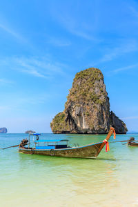 Scenic view of rocks in sea against sky