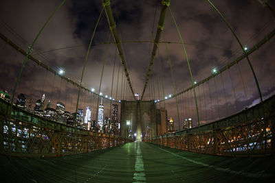 Illuminated bridge against sky at night