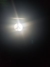 Low angle view of illuminated lights against bright sun