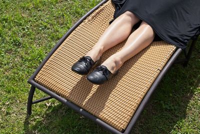 Low section of woman sitting on grass