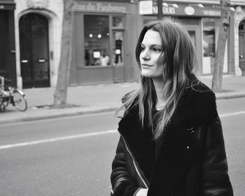 Portrait of woman standing on road