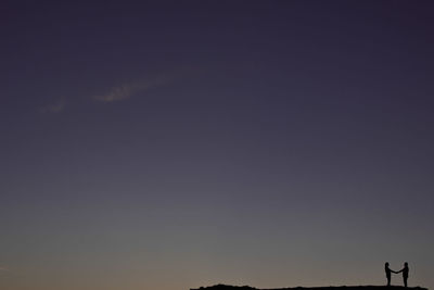 Low angle view of silhouette landscape against sky during sunset