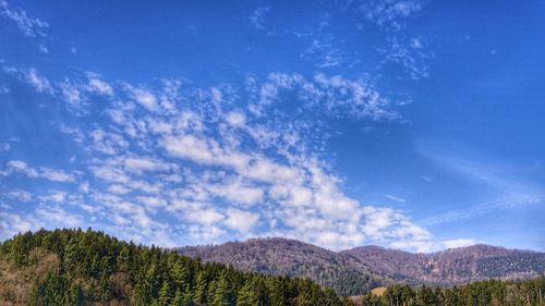 Scenic view of mountains against blue sky