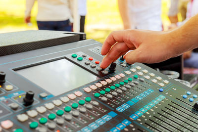 Close-up of cropped hands using sound mixer