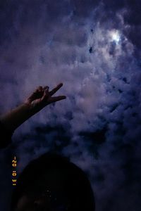 Low angle view of silhouette hand against sky at dusk