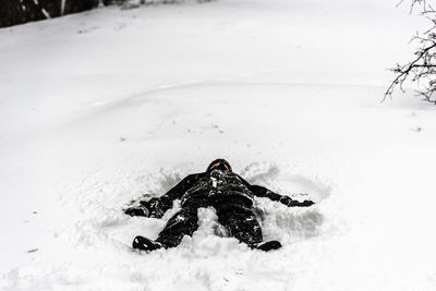 Low section of woman skiing on snow covered field