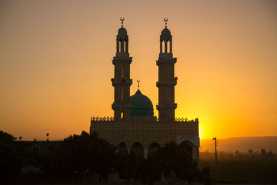 Exterior of historic building against sky during sunset