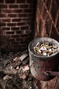 High angle view of cigarettes on bin hanging at wall